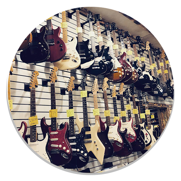 slider-circle Guitars displayed in pawn shop